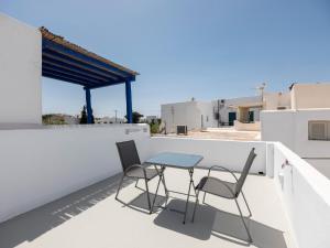 a table and two chairs on a balcony at M&M Parikia's Old Town Studio in Parikia +16 photos