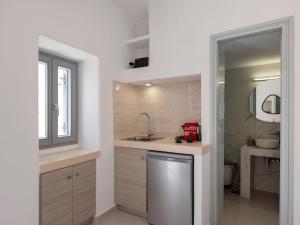 a small kitchen with a sink and a mirror at M&M Parikia's Old Town Studio in Parikia