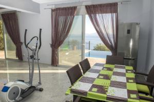 a dining room with a table and a vacuum at Villa Daniella studio with private pool in Nisakion