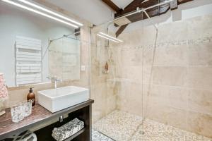 a bathroom with a sink and a shower at Chateau de la Vieille Chapelle in Lugon et l’Ile du Carney