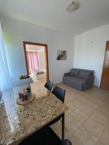 a living room with a table and a couch at Apartman Dubravka 1 in Orebić +8 photos