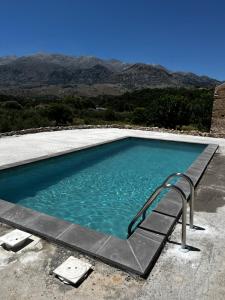 a swimming pool with a stairway leading into the water at Pulchra Campis,Private Pool,Wifi,Parking in Nerokoúros