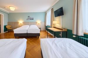Łóżko lub łóżka w pokoju w obiekcie Hotel Limmathof