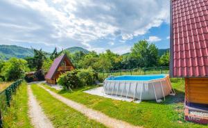 a backyard with a hot tub and a house at Pyramid Energy House in Visoko