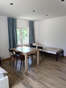a room with a table and chairs and a bed at Letnia Oaza "Akacja" in Sobienie Jeziory +37 photos