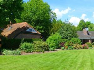 a house with a yard with green grass at Morning sun Comfortable holiday residence in Westerstede