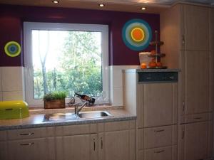 a kitchen with a sink and a window at Morning sun Comfortable holiday residence in Westerstede +12 photos