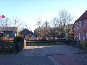 a house with a fence and a yard with houses at Neeb Comfortable holiday residence in Gammendorf