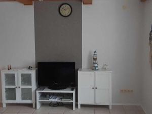 a living room with a tv and a white cabinet at Neeb Comfortable holiday residence in Gammendorf