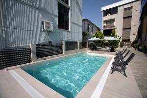 a swimming pool on the side of a building at Boutique Hotel Elite in Kobuleti