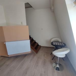 a small room with two stools and a staircase at Bordeaux in Sângeorgiu de Mureș