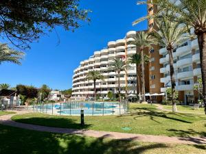 duży apartamentowiec z basenem i palmami w obiekcie Marbesa Marbella Apartment w Marbelli +20 zdjęć