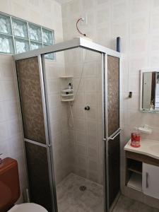 a bathroom with a shower with a toilet and a sink at Brisa do Mar Village in Salvador