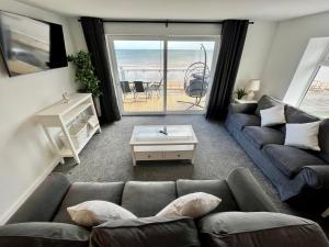 ブリドリントンにあるSeaside Escapes, Bridlingtonのソファがあり海が見えるリビングルーム