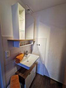 a white bathroom with a sink and a mirror at Allgäuer Landhaus in Fischen +91 photos