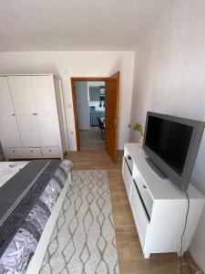 a bedroom with a tv on a white dresser at Apartman Dubravka 1 in Orebić