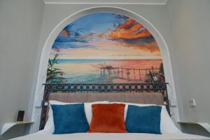 a bedroom with a painting above a bed at Dimora del Corso Luxury house in Pescara