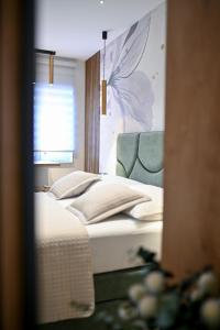 Posteľ alebo postele v izbe v ubytovaní Apartments and Rooms Nekic
