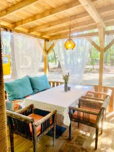 a table and chairs on a patio with a couch at Каравана Безвремие in Chernomorets +22 photos