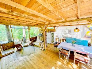 a room with a bed and a table and chairs at Каравана Безвремие in Chernomorets