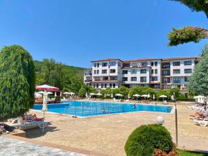a hotel with a swimming pool in front of a building at Apartment C51 in Rogachevo