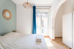 En eller flere senge i et værelse på Appartement 3 chambres en hyper centre de Grenoble