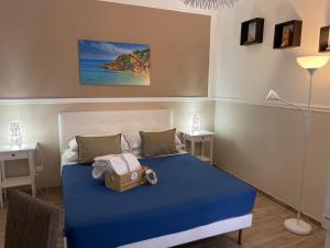 a bedroom with a blue bed with a box on it at B&B La Torre in Realmonte