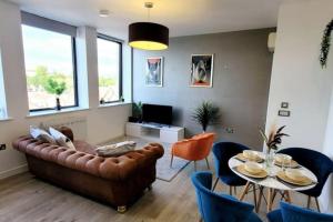 a living room with a couch and a table at City view luxury by BSE Homes in Chelmsford
