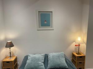a bedroom with a bed and two night stands with lamps at Hôtel La Villa Patricia - Charme et Tradition in Villefranche-sur-Mer