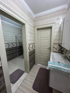 a bathroom with a tub and a sink and a door at Isikli Kale Hotel in Çaykara +188 photos