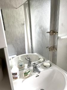 a bathroom with a white sink and a mirror at Vallvikshuset in Vallvik +68 photos