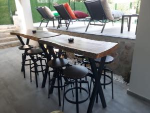 a group of tables and stools in a room at Villa Vineyard in Fethiye