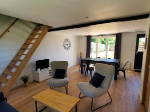 a living room with a dining room table and chairs at Gite des Plantis in Senneville-sur-Fécamp