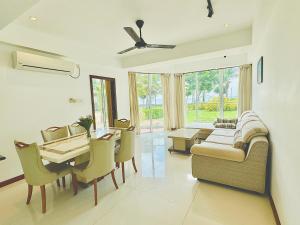 a living room with a table and a dining room at Pearl Of Ocean Front in Trincomalee