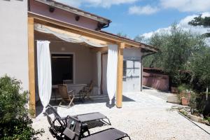 a pavilion with a table and chairs on a patio at Villa il Poderino in Marina di Campo