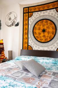 a bedroom with a bed with a painting on the wall at L'isola felice in Cecina