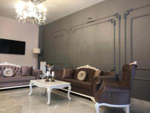 a living room with couches and a table and a chandelier at Rinascente in Edirne