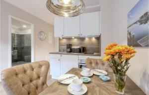 a kitchen and dining room with a table and chairs at Baltischer Hof Apartment 23 in Boltenhagen