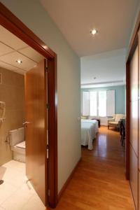Łóżko lub łóżka w pokoju w obiekcie Gran Hotel Aqualange - Balneario de Alange