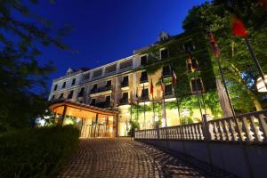 budynek z flagami przed nim w nocy w obiekcie Gran Hotel Aqualange - Balneario de Alange w mieście Alange