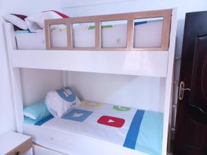 a childs bunk bed with a backpack on it at شاليه قرية بلولاجون راس سدر - 3 غرف و2 حمام in Ras Sedr +47 photos