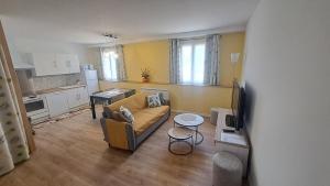 a living room with a couch and a kitchen at Jazz et Vacances in Monlezun