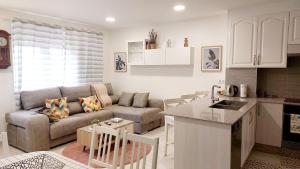 a kitchen and living room with a couch and a table at AGRO da FONTE- Apartamento in Muros