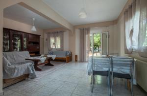 a living room with a couch and a table at Villa Kali-mera in Sykia Chalkidikis