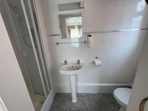 a bathroom with a sink and a toilet at The Northdale Hotel Ltd in Skegness