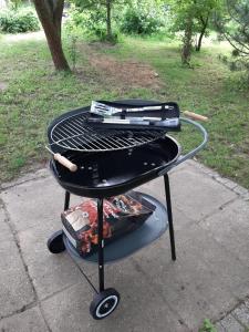 a grill with two hot dogs on top of it at Noclegi w Dolinie Drwęcy in Kurzętnik