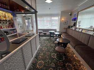 a bar with stools and a counter in a store at The Northdale Hotel Ltd in Skegness