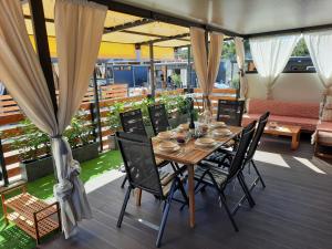 a wooden table and chairs on a patio at Mobile home Sirena Drage in Drage