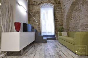 a living room with a couch and a tv at La Puglia di Claudia in Ruvo di Puglia
