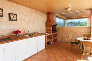 a kitchen with a counter and a table and a window at Villa Los Azules with pool and jacuzzi in Maspalomas +25 photos
